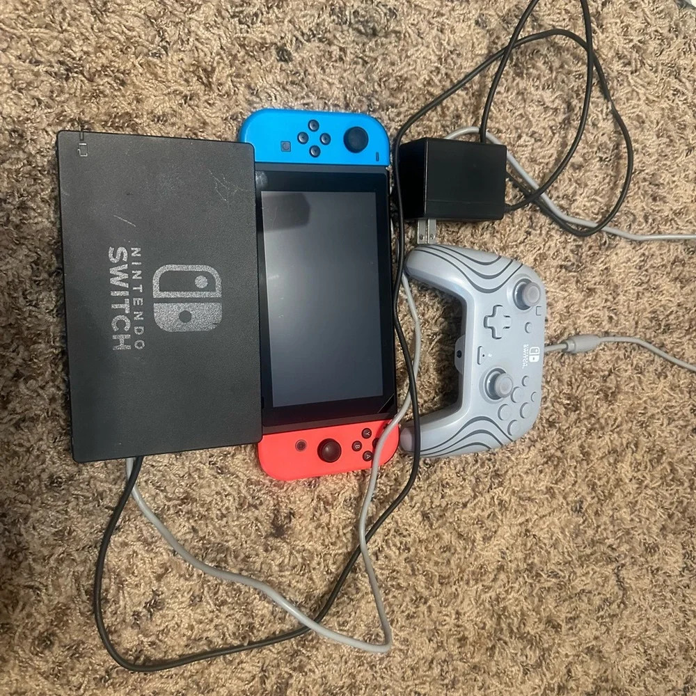 Nintendo Switch Console with Red and Blue Joy-Con and Gray Controller